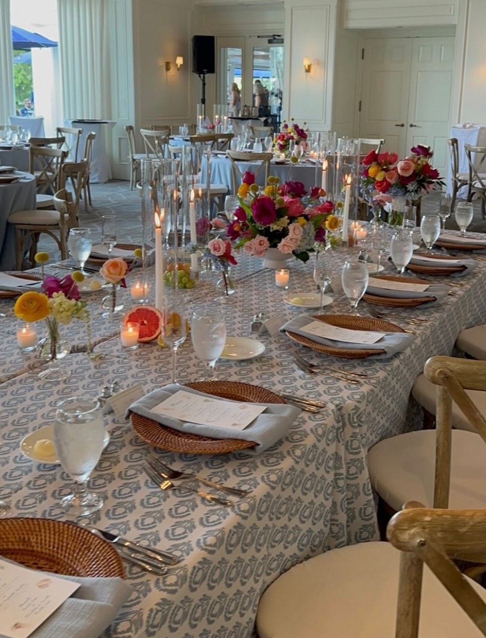 Custom printed linen tablescape with colorful floral centerpieces